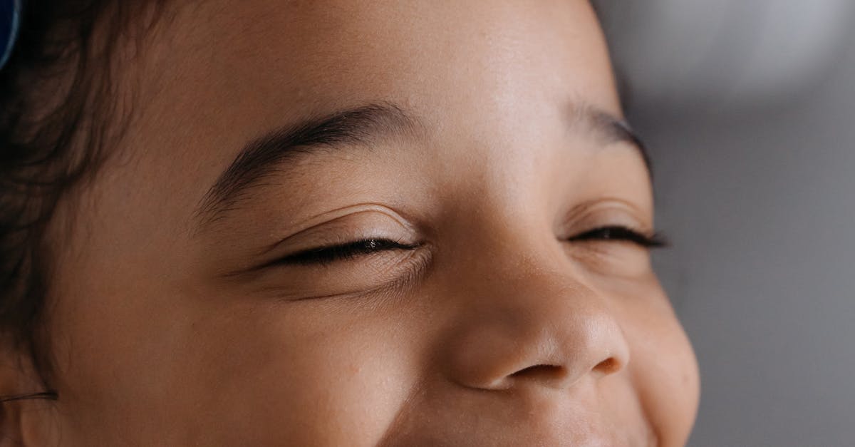 Home Smiling child undergoing dental x-ray at a clinic, emphasizing dental health and care.